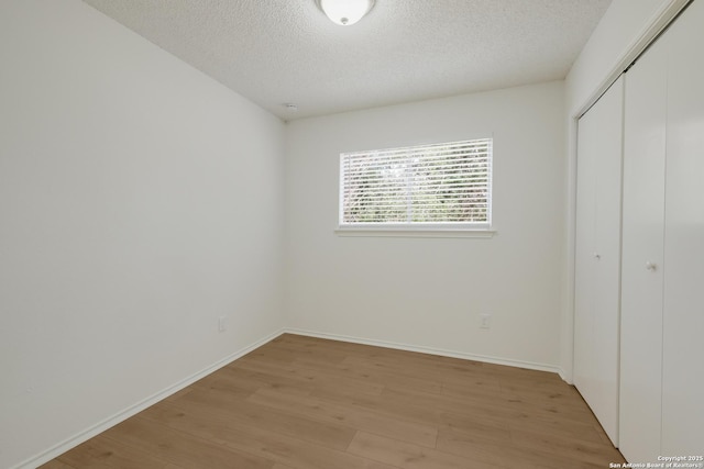 4204 Golden Spice Dr, San Antonio, TX 78222 - unfurnished bedroom with a textured ceiling, light wood-type flooring, and a closet