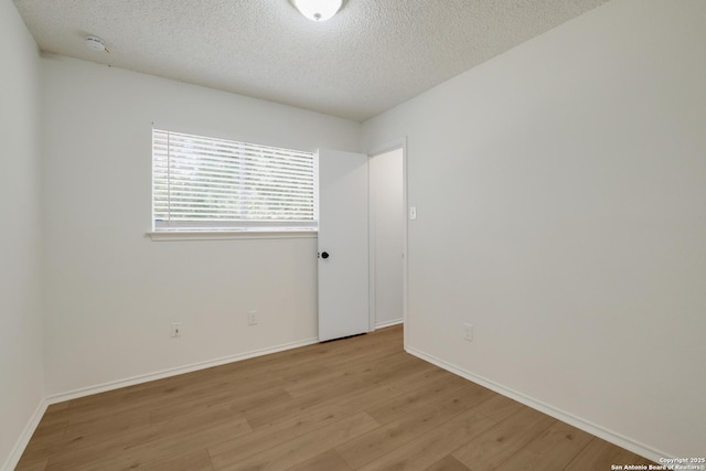 4204 Golden Spice Dr, San Antonio, TX 78222 - unfurnished room featuring light wood-style flooring, a textured ceiling, and a smoke detector