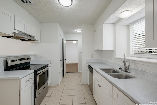 4204 Golden Spice Dr, San Antonio, TX 78222 - kitchen featuring stainless steel appliances, under cabinet range hood, a textured ceiling, white cabinets, and light countertops