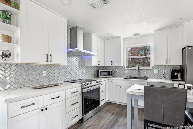 931 Republic Rd, New Caney, TX 77357 - kitchen with appliances with stainless steel finishes, wall chimney exhaust hood, open shelves, dark wood-type flooring, and white cabinets