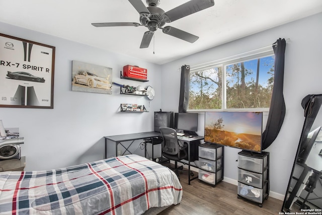 931 Republic Rd, New Caney, TX 77357 - bedroom with wood finished floors, a ceiling fan, and an office area