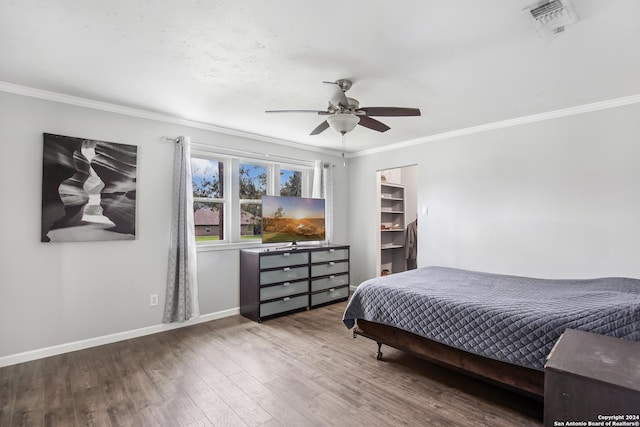 931 Republic Rd, New Caney, TX 77357 - bedroom with crown molding, wood finished floors, and a ceiling fan