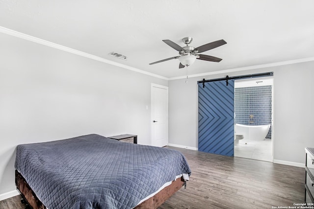 931 Republic Rd, New Caney, TX 77357 - bedroom with wood finished floors, a barn door, ornamental molding, and a ceiling fan