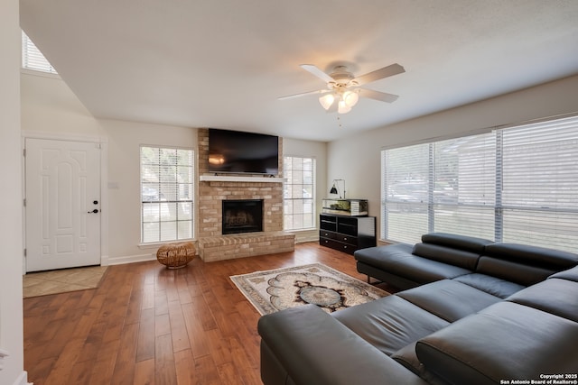 2516 Hidden Grv, Schertz, TX 78154 - living room featuring ceiling fan, wood finished floors, and a brick fireplace