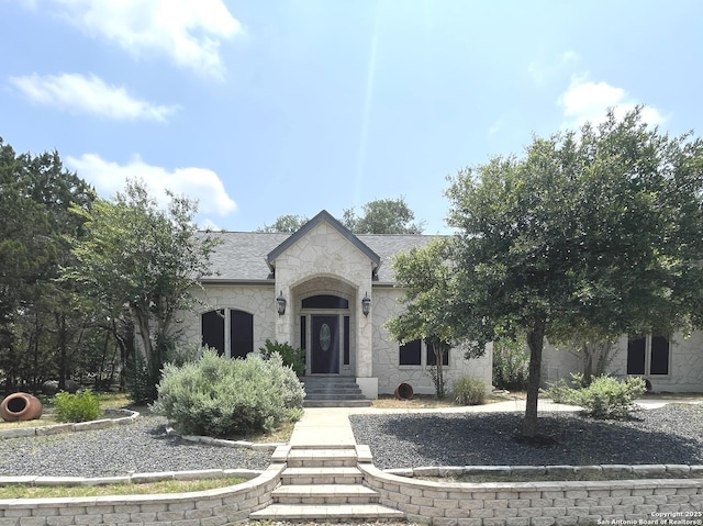 614 Slumber, San Antonio, TX 78260 - french country style house featuring stone siding, an attached garage, and roof with shingles