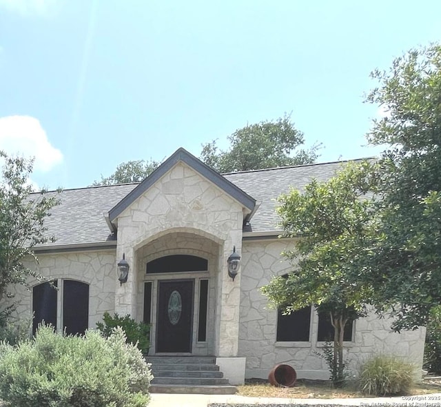 614 Slumber, San Antonio, TX 78260 - entrance to property featuring stone siding and roof with shingles
