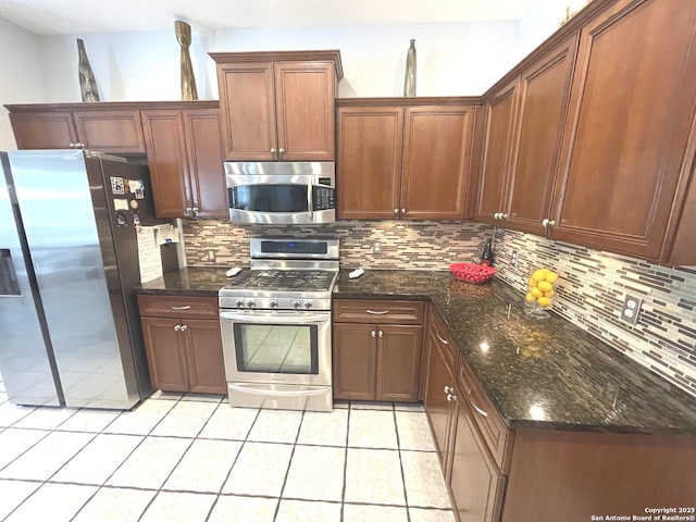614 Slumber, San Antonio, TX 78260 - kitchen featuring stainless steel appliances, backsplash, light tile patterned floors, and dark stone countertops