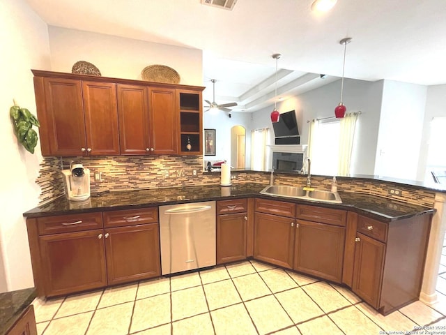 614 Slumber, San Antonio, TX 78260 - kitchen featuring decorative backsplash, ceiling fan, stainless steel dishwasher, a peninsula, and hanging light fixtures