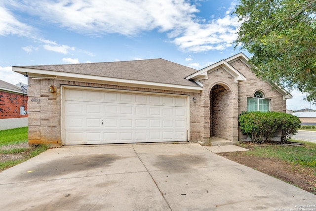 6051 Still Mdw, San Antonio, TX 78222 - view of front of home featuring brick siding, concrete driveway, an attached garage, and a shingled roof