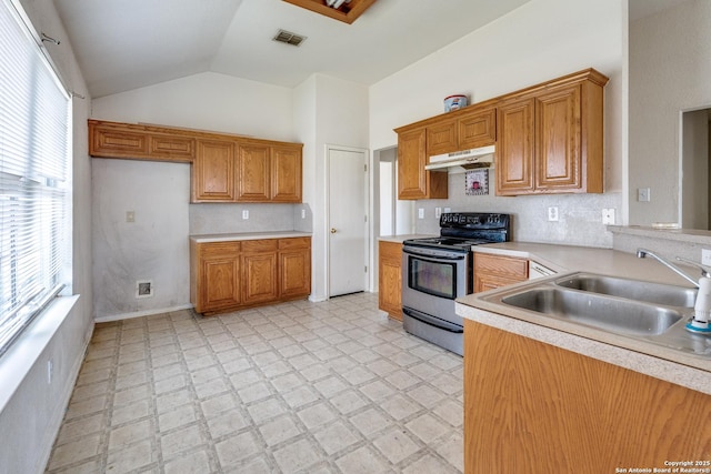 6051 Still Mdw, San Antonio, TX 78222 - kitchen featuring stainless steel electric range, under cabinet range hood, light countertops, vaulted ceiling, and brown cabinetry