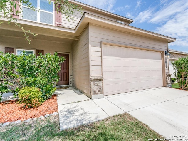 9410 Sandy Rdg, San Antonio, TX 78239 - doorway to property featuring a garage and driveway