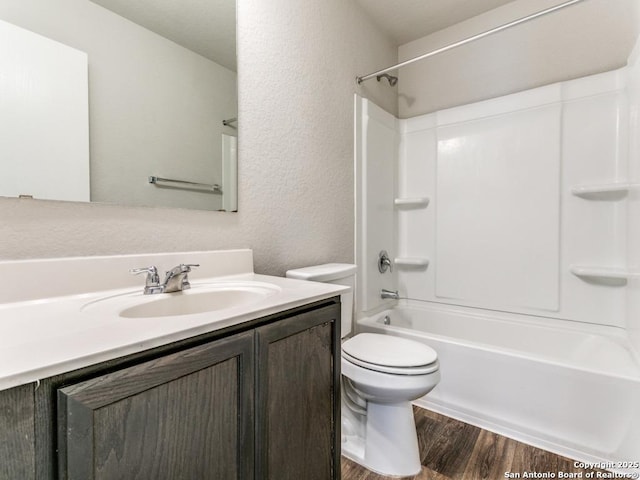 9410 Sandy Rdg, San Antonio, TX 78239 - full bathroom with wood finished floors, vanity, washtub / shower combination, and a textured wall