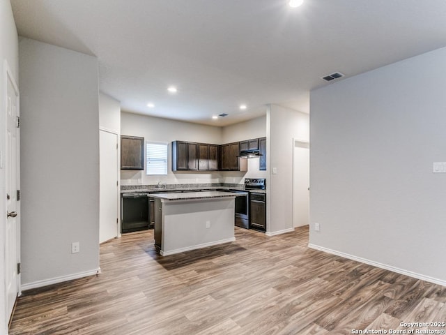9410 Sandy Rdg, San Antonio, TX 78239 - kitchen with stainless steel electric stove, light wood-style floors, dark brown cabinetry, recessed lighting, and a center island