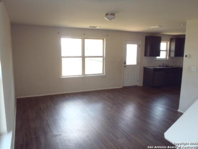 2201 Wirtz, Seguin, TX 78155 - unfurnished living room with dark wood-style floors