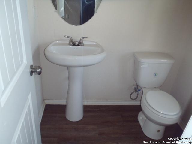 2201 Wirtz, Seguin, TX 78155 - bathroom featuring wood finished floors and toilet