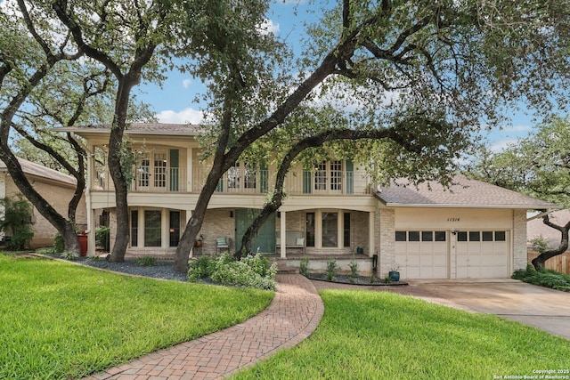 11214 Whisper Fls, San Antonio, TX 78230 - view of front of house featuring a garage, concrete driveway, a front yard, and brick siding