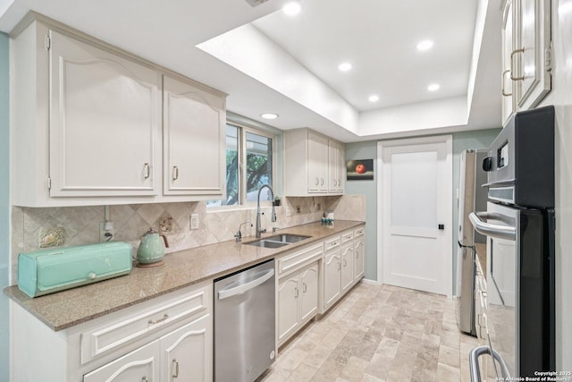 11214 Whisper Fls, San Antonio, TX 78230 - kitchen featuring dishwasher, decorative backsplash, recessed lighting, white cabinetry, and light stone countertops