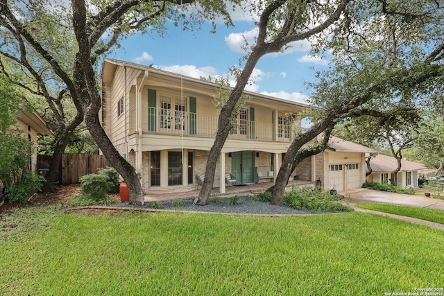 11214 Whisper Fls, San Antonio, TX 78230 - view of front of home featuring driveway, a porch, french doors, an attached garage, and a balcony