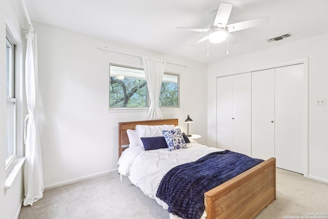 11214 Whisper Fls, San Antonio, TX 78230 - bedroom with light colored carpet, a closet, and a ceiling fan