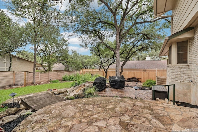 11214 Whisper Fls, San Antonio, TX 78230 - fenced backyard with area for grilling and a patio