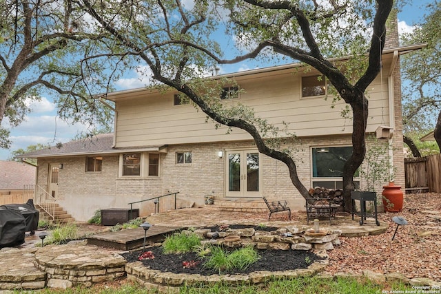 11214 Whisper Fls, San Antonio, TX 78230 - back of house with french doors, brick siding, and a patio area