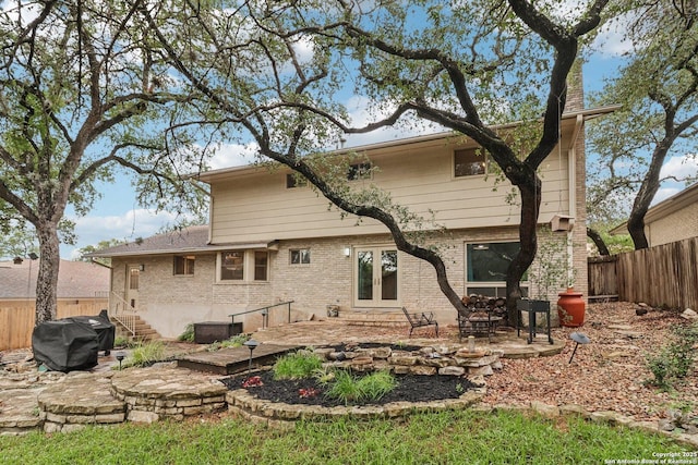 11214 Whisper Fls, San Antonio, TX 78230 - rear view of property with french doors, a fenced backyard, a patio, and brick siding