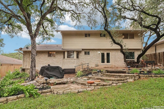 11214 Whisper Fls, San Antonio, TX 78230 - back of property with french doors, a patio, and brick siding