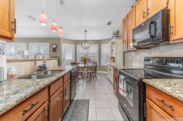 5330 Stormy Hls, San Antonio, TX 78247 - kitchen with black appliances, backsplash, plenty of natural light, and brown cabinetry
