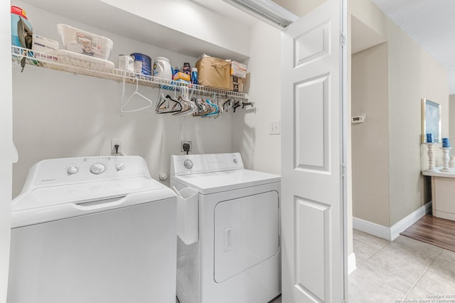 5330 Stormy Hls, San Antonio, TX 78247 - laundry room featuring washing machine and dryer and light tile patterned floors