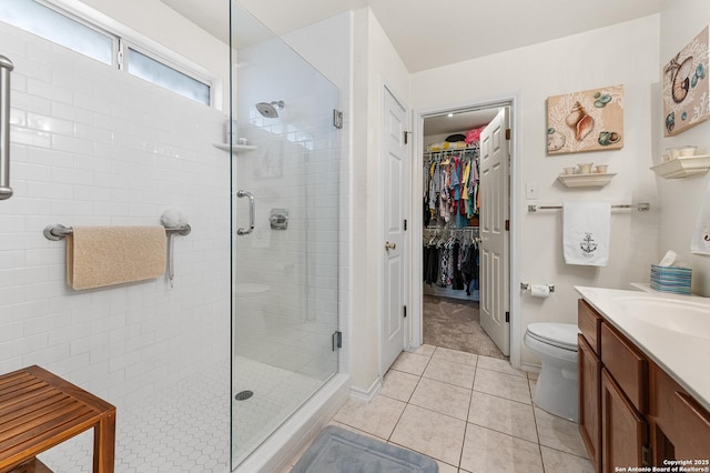 5330 Stormy Hls, San Antonio, TX 78247 - bathroom with a stall shower, vanity, tile patterned flooring, and a spacious closet