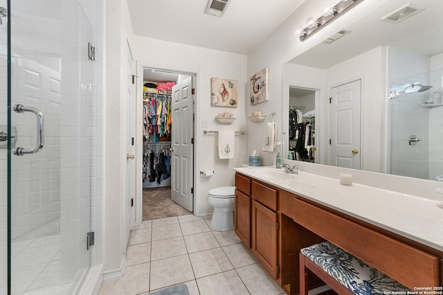5330 Stormy Hls, San Antonio, TX 78247 - full bathroom featuring a walk in closet, vanity, a shower stall, and tile patterned floors