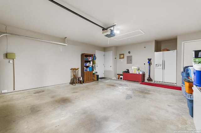5330 Stormy Hls, San Antonio, TX 78247 - garage featuring white fridge with ice dispenser, a garage door opener, and electric panel