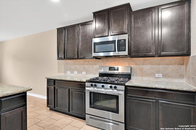 14055 Cremello Fls, San Antonio, TX 78254 - kitchen featuring stainless steel appliances, backsplash, light tile patterned floors, and light stone countertops