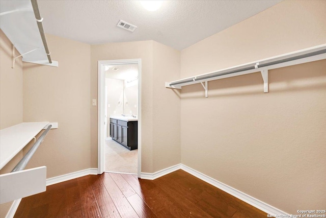 14055 Cremello Fls, San Antonio, TX 78254 - spacious closet featuring dark wood finished floors