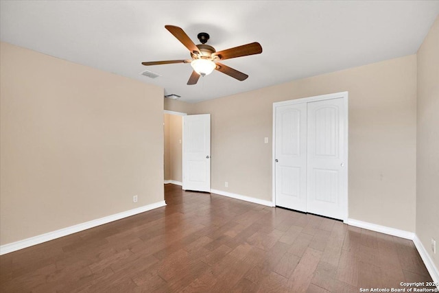 14055 Cremello Fls, San Antonio, TX 78254 - unfurnished bedroom with dark wood finished floors, a closet, and a ceiling fan