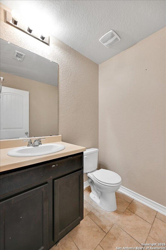 14055 Cremello Fls, San Antonio, TX 78254 - bathroom featuring a textured wall, vanity, a textured ceiling, and tile patterned flooring