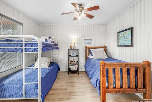 902 Harrison Prt, Oconnor, TX 77982 - bedroom with wood finished floors, a ceiling fan, and wooden walls