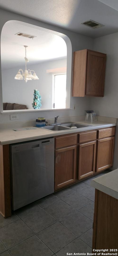 335 Silver Bit, San Antonio, TX 78227 - kitchen featuring dishwasher, dark tile patterned flooring, and pendant lighting