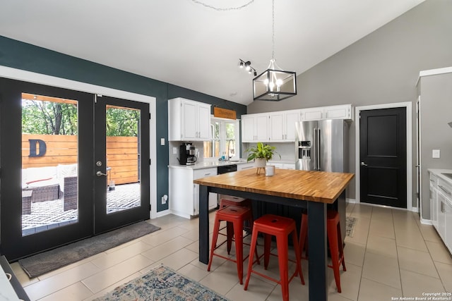 2102 Encino Clf, San Antonio, TX 78259 - kitchen with wood counters, white cabinetry, healthy amount of natural light, french doors, and high vaulted ceiling