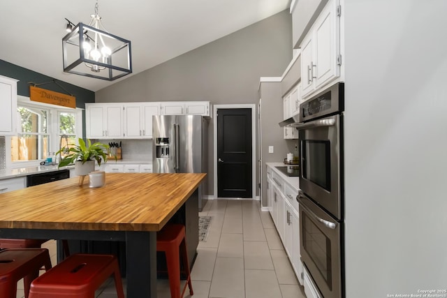 2102 Encino Clf, San Antonio, TX 78259 - kitchen featuring wooden counters, double oven, white cabinetry, black electric stovetop, and a breakfast bar