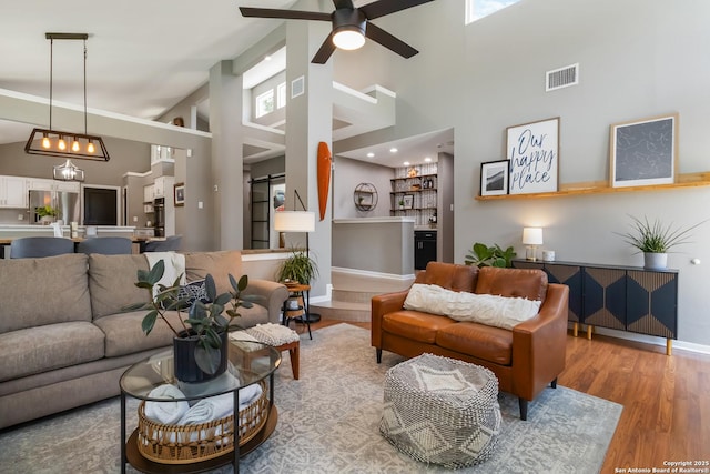 2102 Encino Clf, San Antonio, TX 78259 - living area featuring a towering ceiling, a ceiling fan, and wood finished floors