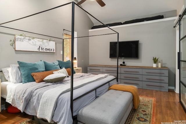 2102 Encino Clf, San Antonio, TX 78259 - bedroom with light wood-style flooring, a barn door, and lofted ceiling