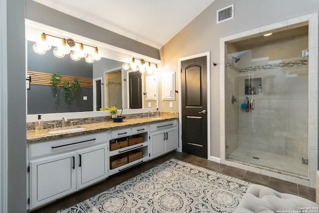 2102 Encino Clf, San Antonio, TX 78259 - bathroom featuring vaulted ceiling, double vanity, and a stall shower