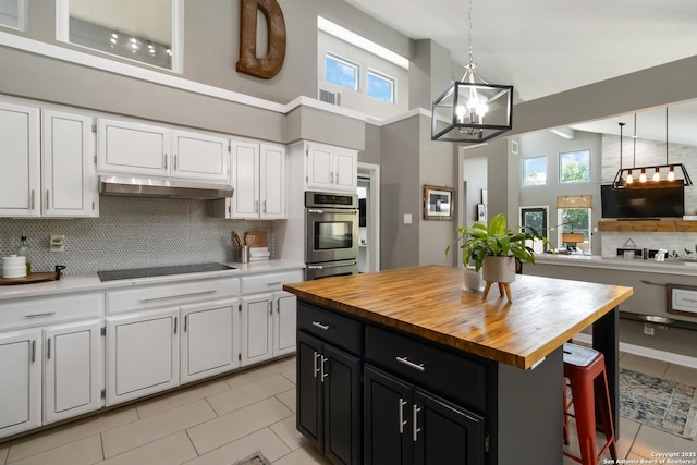 2102 Encino Clf, San Antonio, TX 78259 - kitchen featuring stainless steel oven, wooden counters, dark cabinets, white cabinets, and backsplash