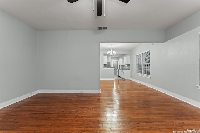 1806 W Mistletoe Ave, San Antonio, TX 78201 - unfurnished living room featuring ceiling fan, a chandelier, and hardwood / wood-style floors