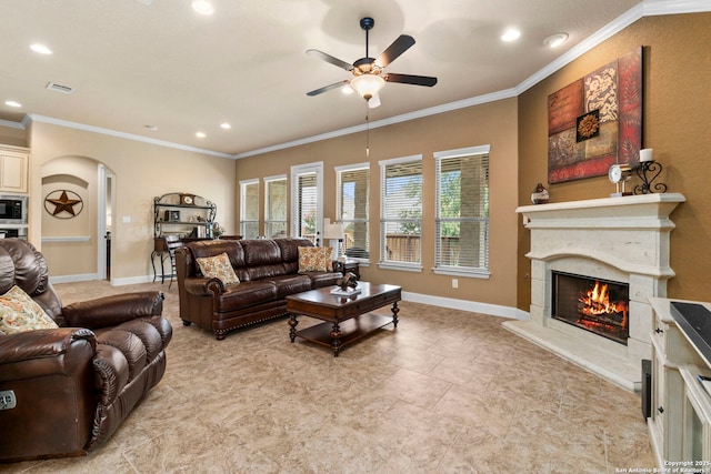 25926 Natal Plum, San Antonio, TX 78261 - living room with arched walkways, ceiling fan, recessed lighting, ornamental molding, and a lit fireplace