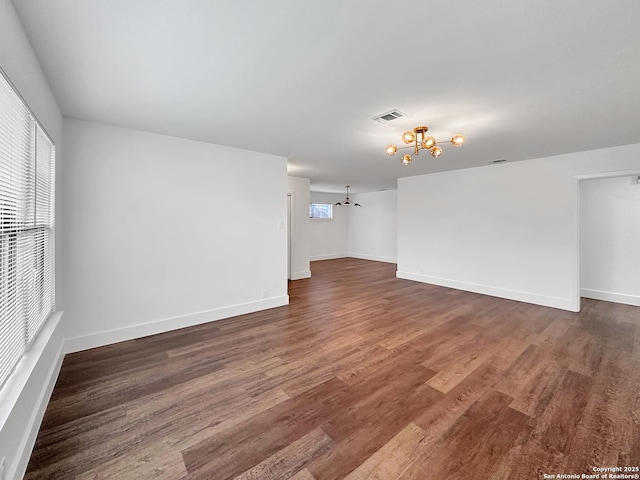 543 Cosgrove, San Antonio, TX 78210 - empty room featuring a chandelier and dark wood-type flooring