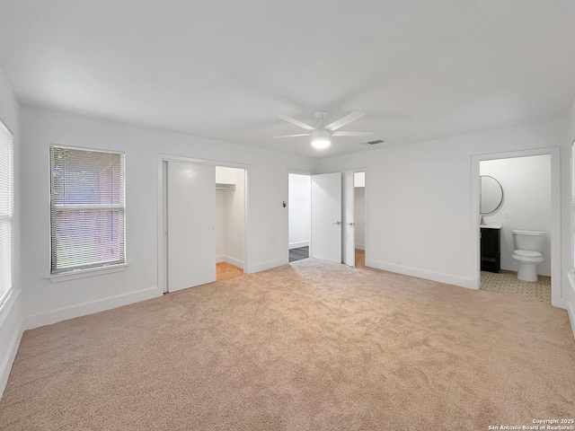 543 Cosgrove, San Antonio, TX 78210 - unfurnished bedroom with carpet flooring, connected bathroom, a walk in closet, and ceiling fan