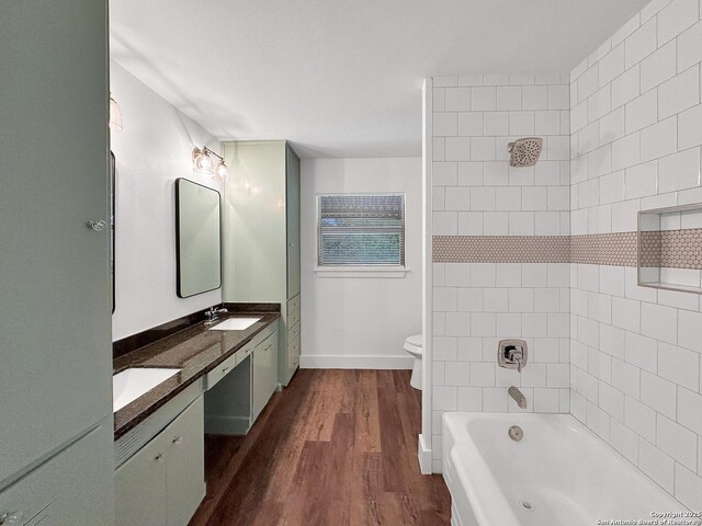 543 Cosgrove, San Antonio, TX 78210 - bathroom featuring double vanity, wood finished floors, and  shower combination
