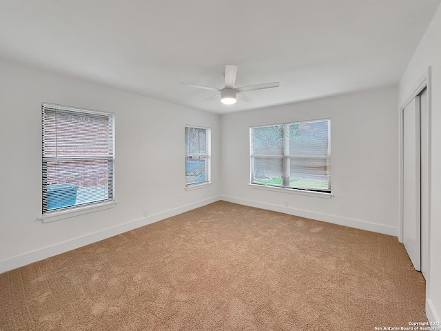 543 Cosgrove, San Antonio, TX 78210 - unfurnished bedroom featuring light carpet, a ceiling fan, and a closet